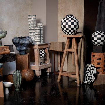 vases sitting on wooden stools and pedestals