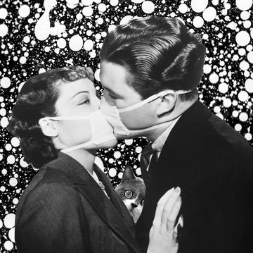 Couple kissing wearing masks
