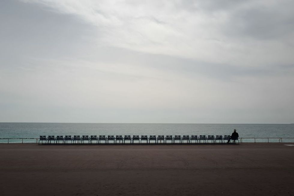 topshot   a man looks at the mediterranean sea on the promenade des anglais in the french riviera city of nice, after a strict lockdown requiring most people in france to remain at home came into effect on march 17, 2020   a strict lockdown requiring most people in france to remain at home came into effect at midday on march 17, 2020, prohibiting all but essential outings in a bid to curb the coronavirus spread photo by valery hache  afp photo by valery hacheafp via getty images
