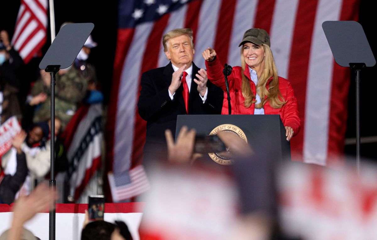 us president donald trump claps as republican incumbent senator kelly loeffler speaks during a rally ahead of senate the runoff in dalton, georgia on january 4, 2021   president donald trump, still seeking ways to reverse his election defeat, and president elect joe biden converge on georgia on monday for dueling rallies on the eve of runoff votes that will decide control of the us senate trump, a day after the release of a bombshell recording in which he pressures georgia officials to overturn his november 3 election loss in the southern state, is to hold a rally in the northwest city of dalton in support of republican incumbent senators kelly loeffler and david perdue photo by sandy huffaker  afp photo by sandy huffakerafp via getty images