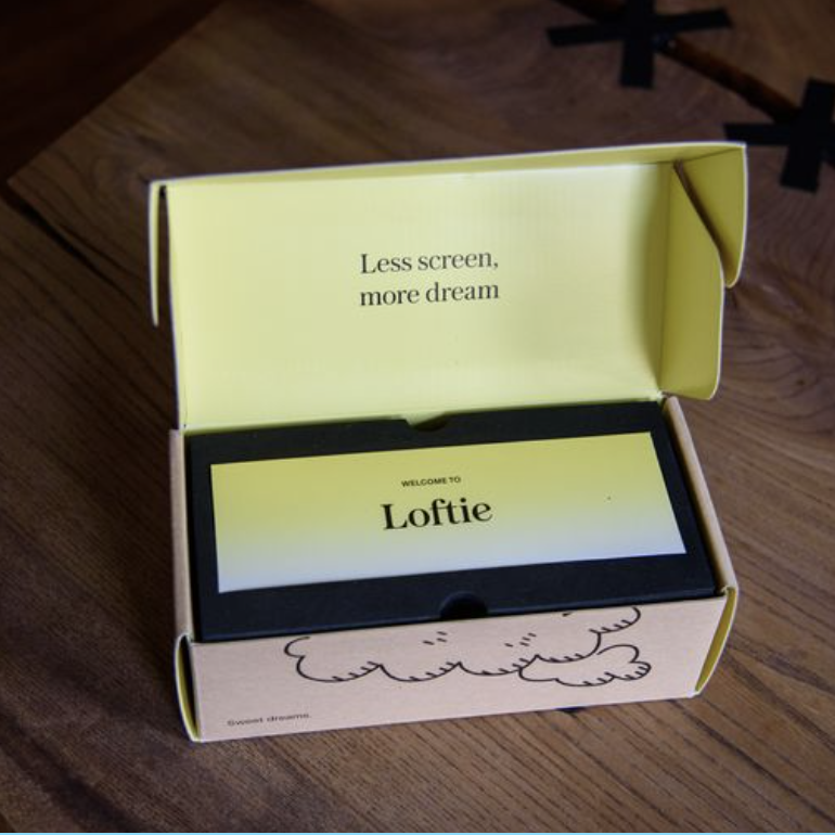 loftie smart alarm clock review in yellow box on wood