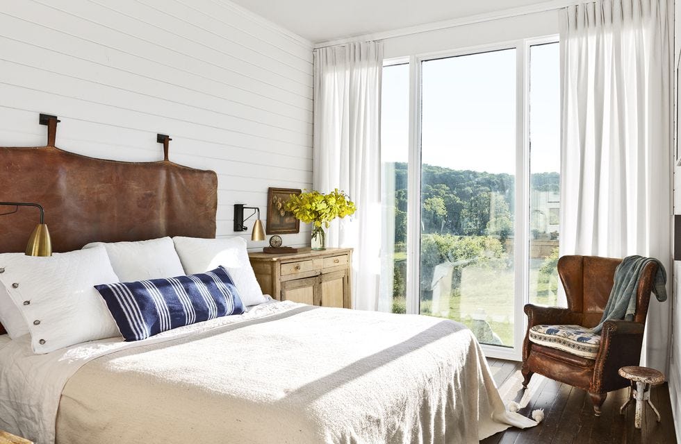 white airy bedroom with leather headboard