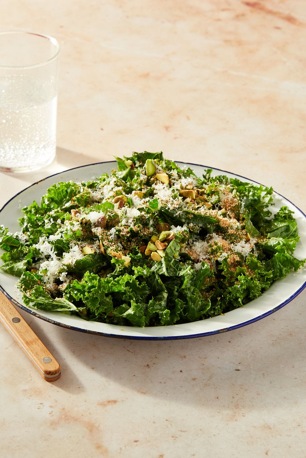 curly kale salad topped with toasted breadcrumbs, pistachios, and pecorino