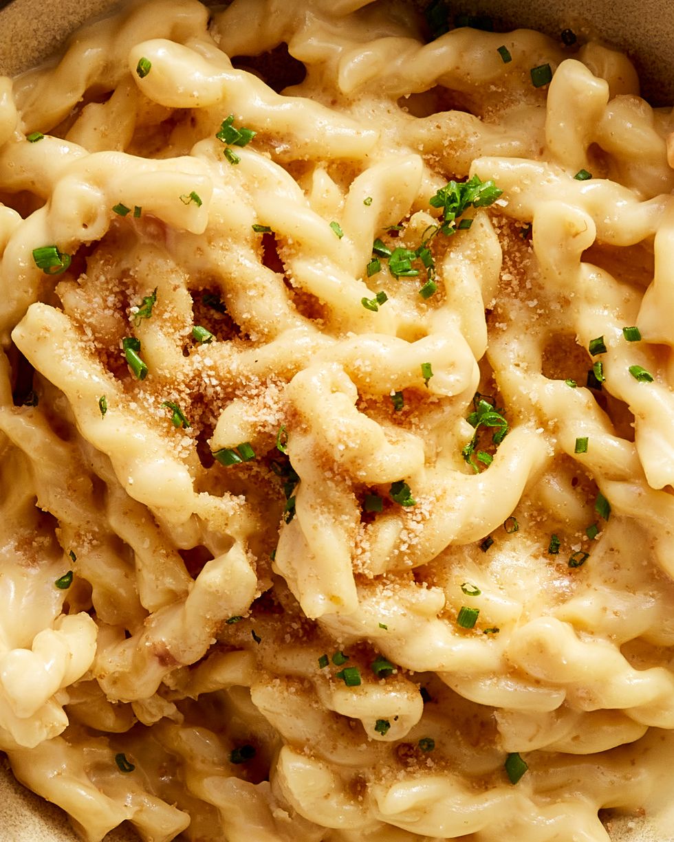 close up of gemelli pasta and cheese topped with breadcrumbs and chives