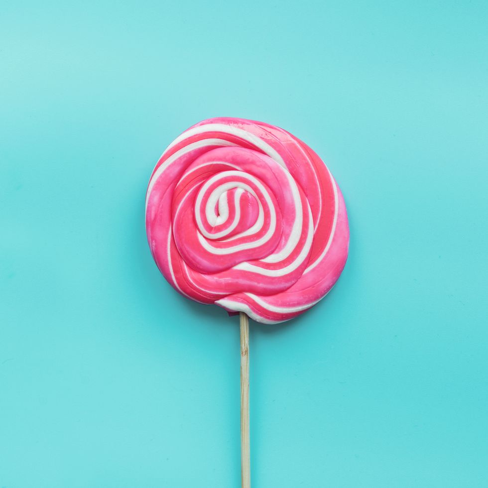 lollipops candy swirl white and pink on pastel blue