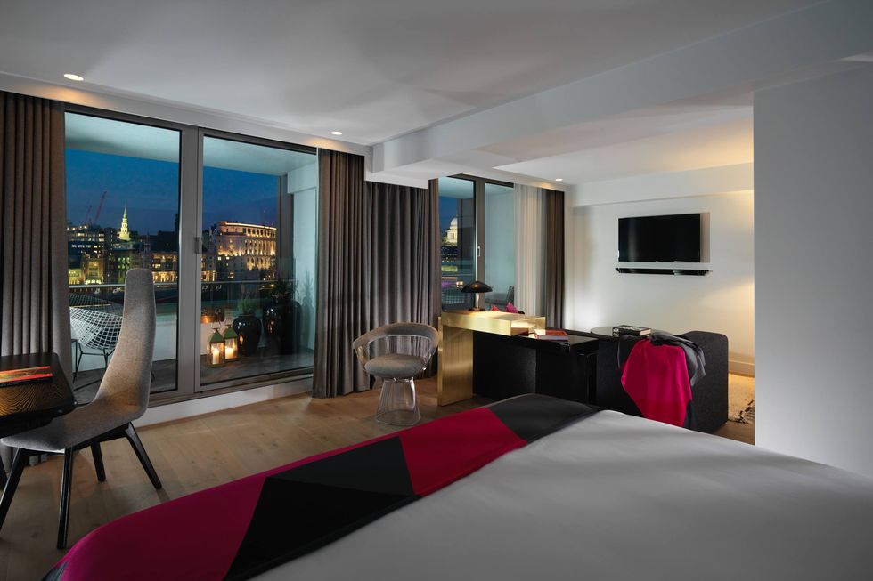 a bedroom with a large window at sea containers