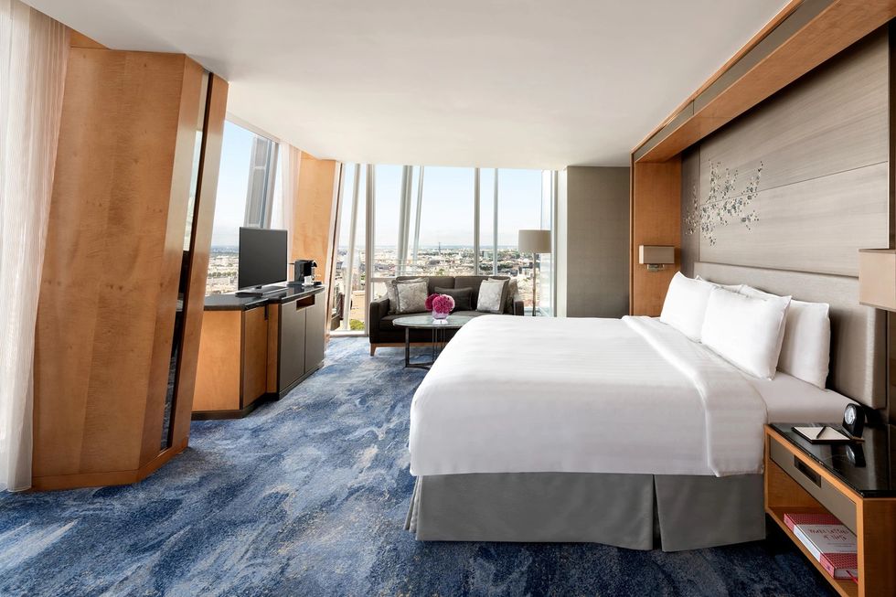 a bedroom with a bed and a desk at shangri la the shard