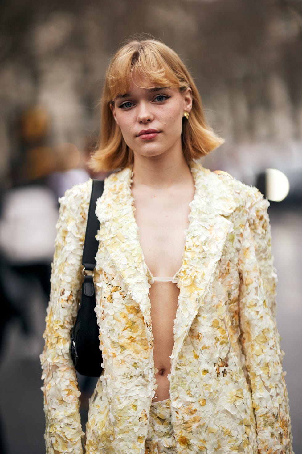 a model wearing an avantgarde floral outfit in a fashionforward setting best fringe hair at london fashion week