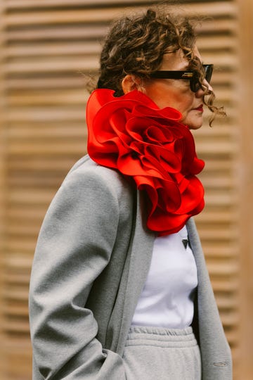 a person with a red rose in the hair