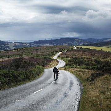 lone cyclist on winding road