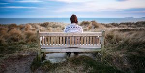 lonely woman on beach bench