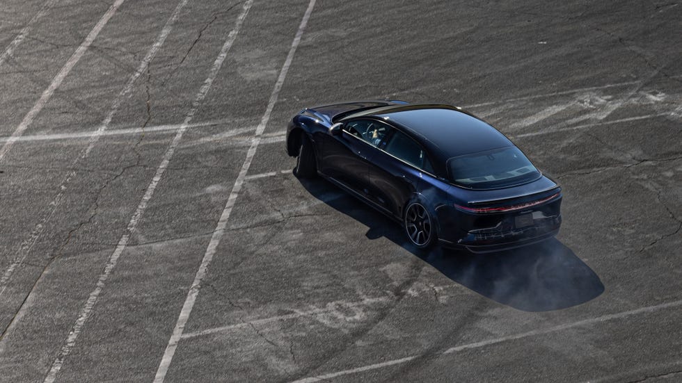 a blue sports car on a road