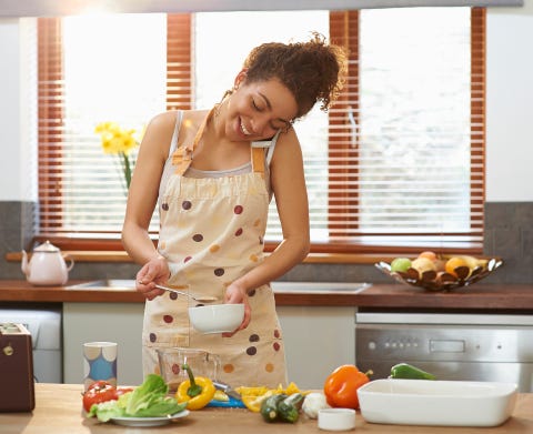 Woman talking on phone whilst cooking. Woman talking on phone whilst cooking.