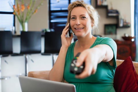 Woman on phone watching television Woman on phone watching television