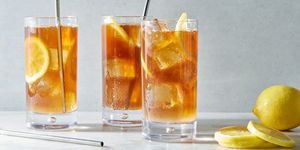 long island iced tea cocktail with lemon slices and a splash of coca cola