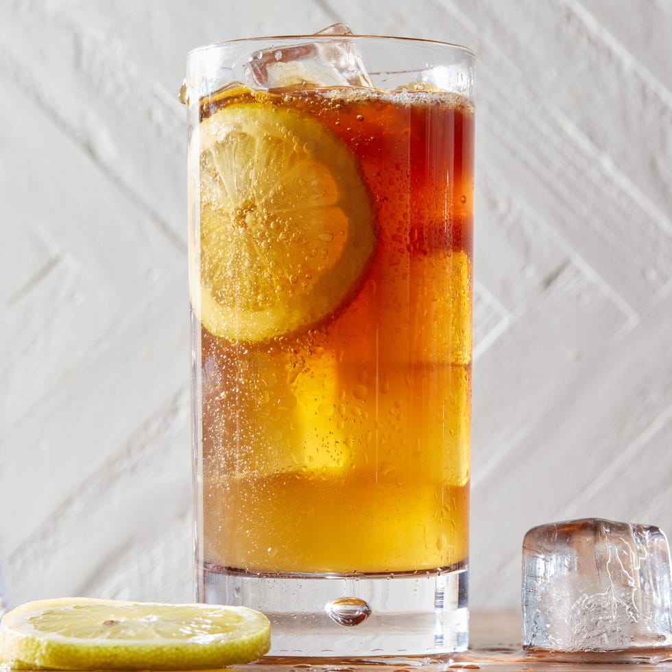 long island iced tea cocktail with lemon slices and a splash of coca cola