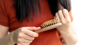 long loss hair fall on woman brush with and woman looking at her