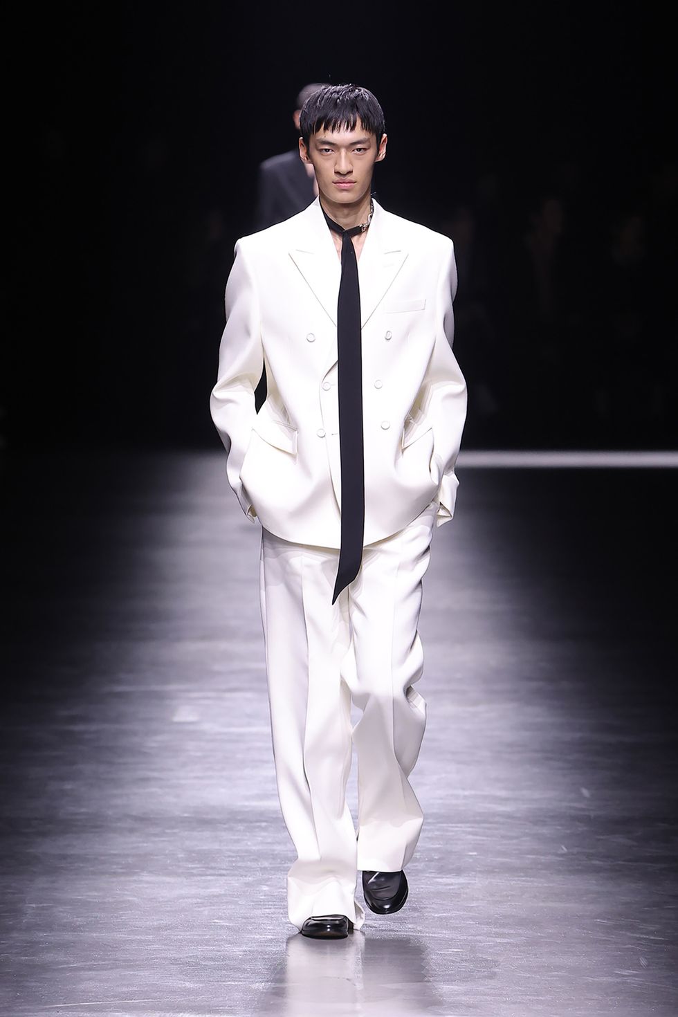 gucci show at milan mens fashion week a model wearing a white suit