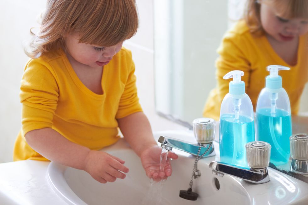 Toddler using bathroom sink