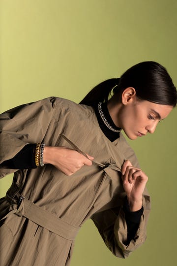 model in trenchcoat and fope jewellery