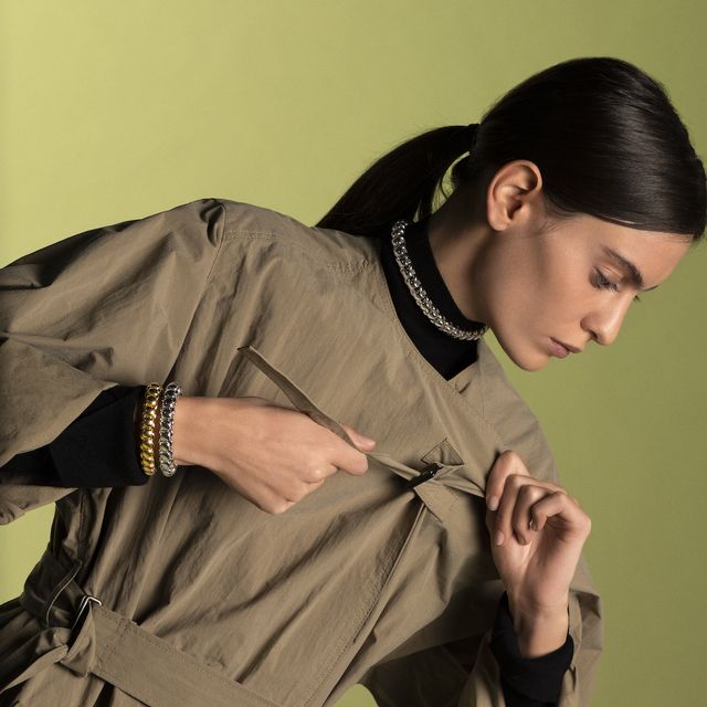 model in trenchcoat and fope jewellery