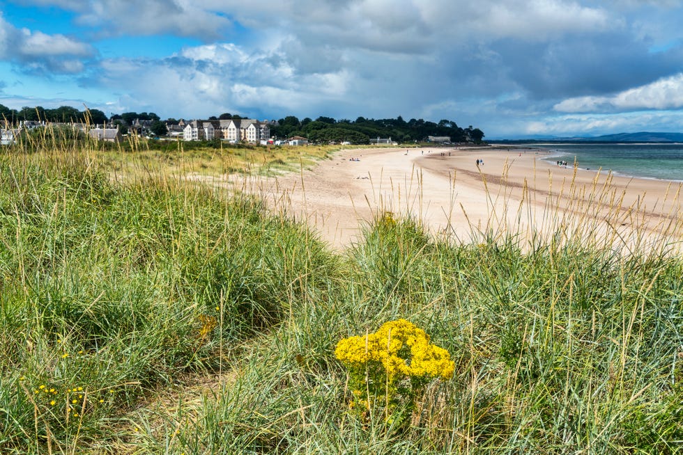 looking west along beach at nairn, moray firth, scotland uk