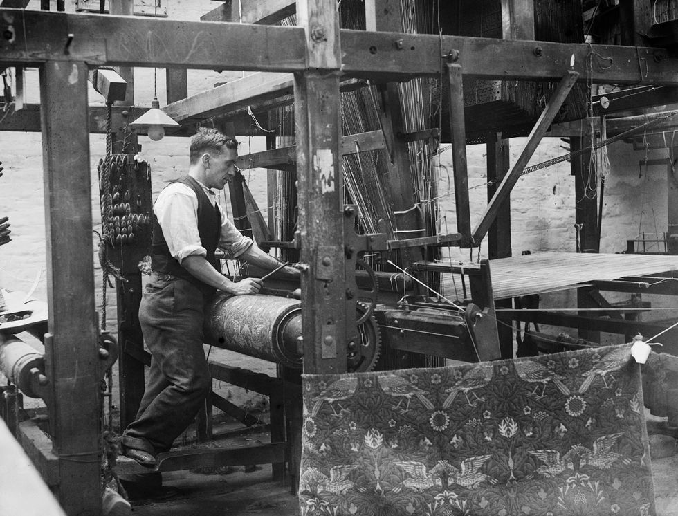 black and white photo of man on loom