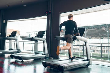 back view of a man running on a treadmill