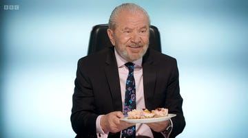 lord alan sugar holding a plate of cheesecakes on the apprentice