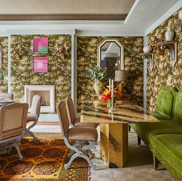 the large dining room is wrapped in a tapestry verdure fabric, giving it the leafy feel of a conservatory the chairs are by maison jansen 1960s italian marble table, willy rizzo london chelsea townhouse designed by lorenzo castillo immersive prints, radiant seating, and a welcoming spirit