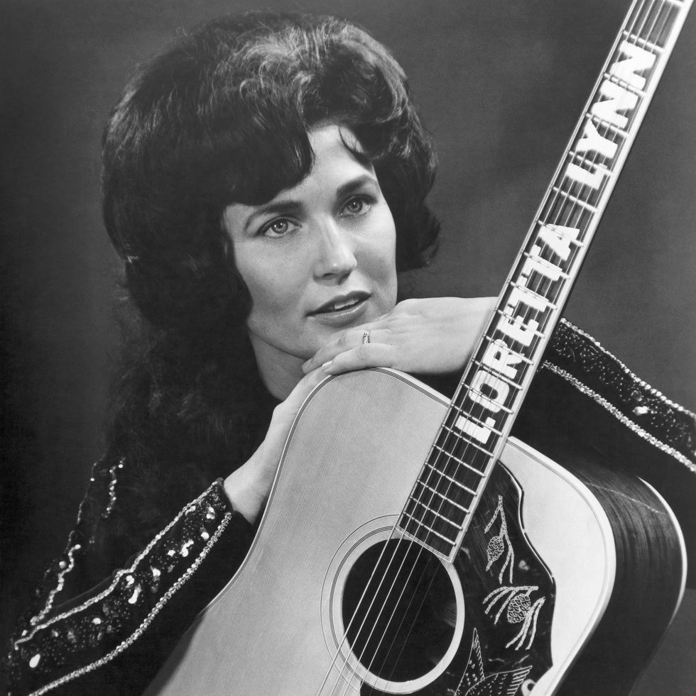 nashville, tn circa 1962 loretta lynn poses for a portrait holding a guitar that has her name spelled down the fretboard in circa 1961 in nashville, tennessee photo by michael ochs archivesgetty images