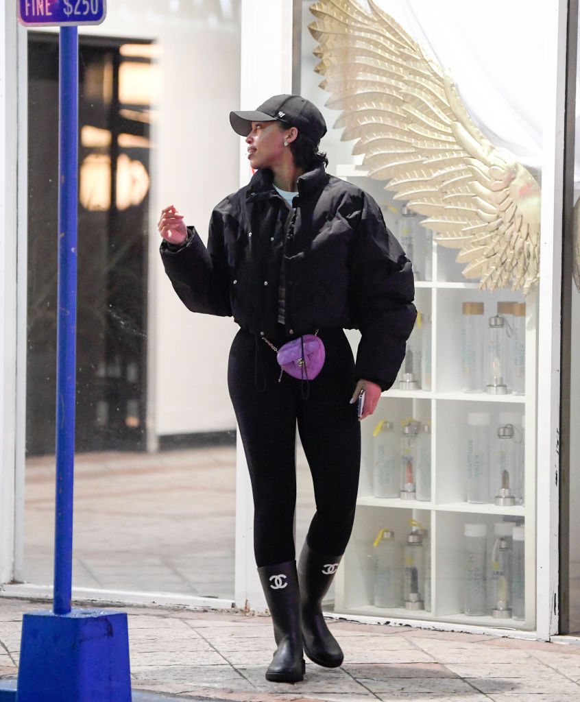 Lori Harvey Runs in Chanel Rainboots and a Puffer