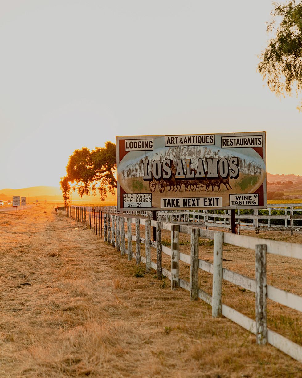 los alamos california road sign at sunset on a rustic fence