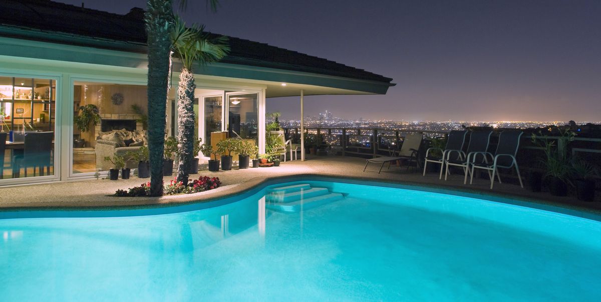 illuminated pool at night with city in background, los angeles, california, united states