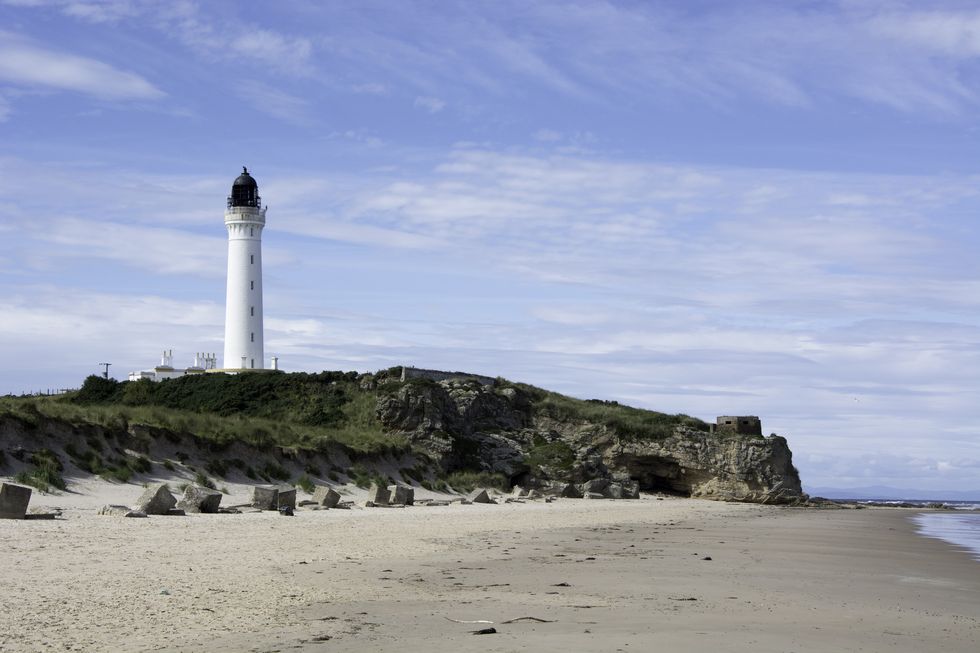 Coastal Scene with lighthouse and sea caves