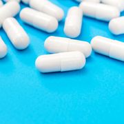 white antidepressant pills on a blue background