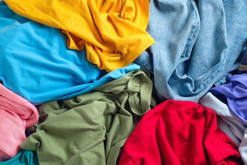 lots of bright dirty colorful scattered clothes, abstract background the concept of homework, lack of time for household chores
