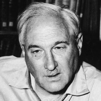 circa 1955:  British anthropologist Dr Louis S B Leakey (1903 - 1972) sits at a table with four skulls, including the skull of the world's earliest known man.  (Photo by Hulton Archive/Getty Images)