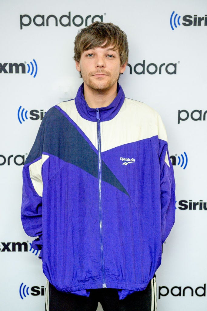 Louis Tomlinson wears a tracksuit on the red carpet