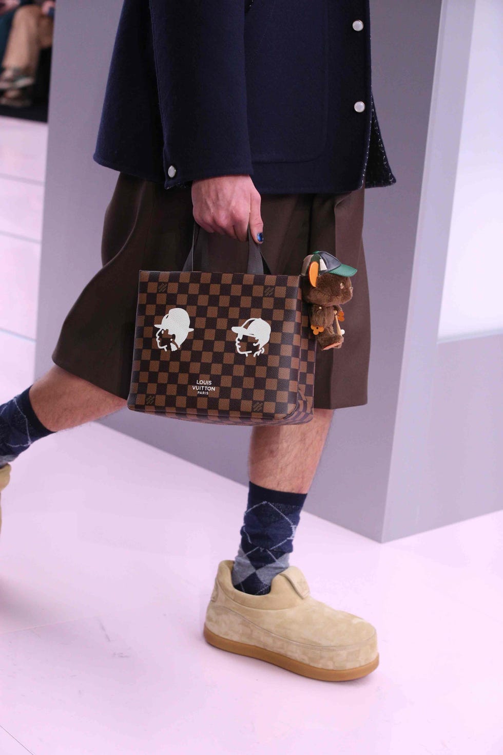 fashion model showcasing a louis vuitton bag and unique outfit