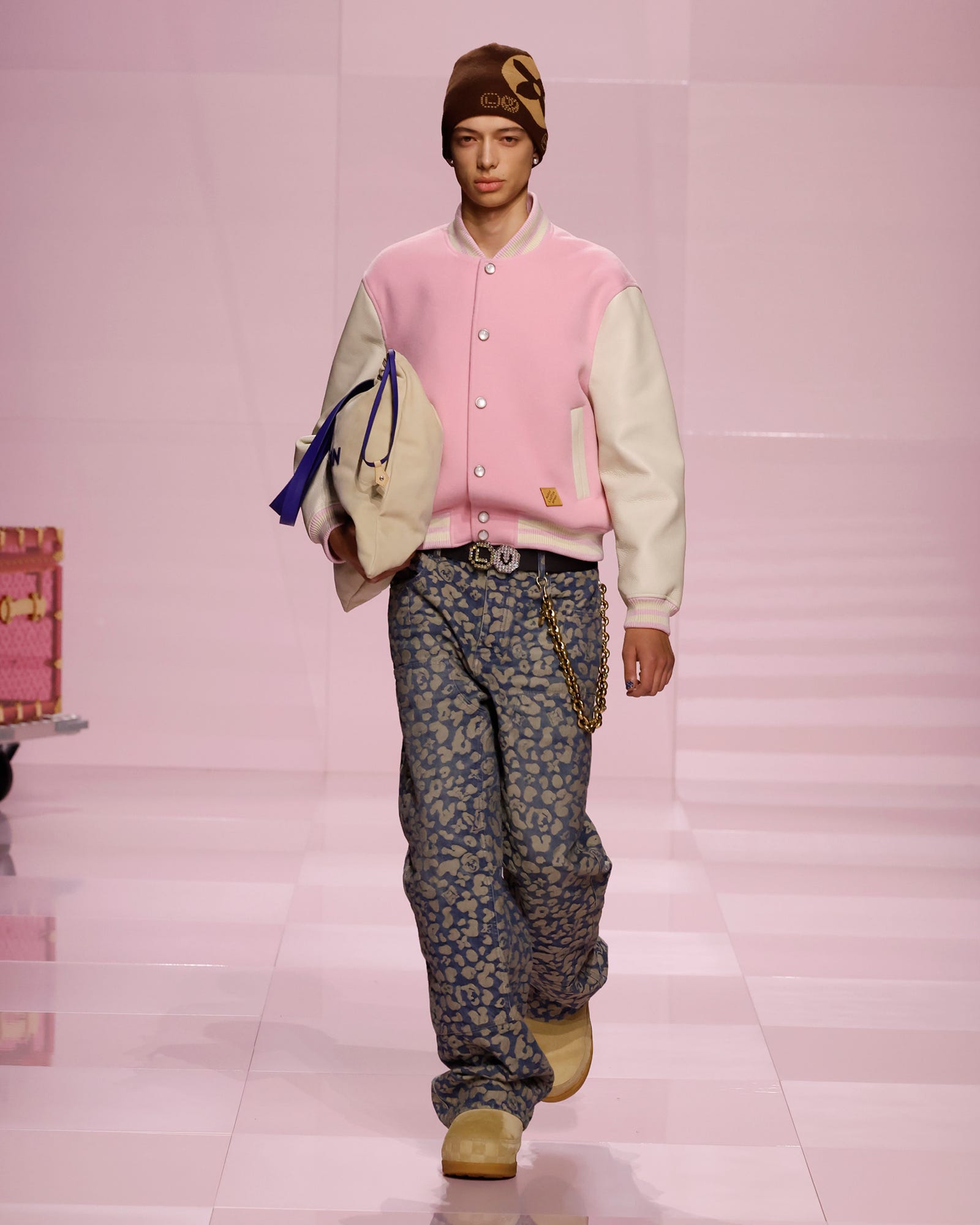 a person walking on a runway wearing a stylish outfit
