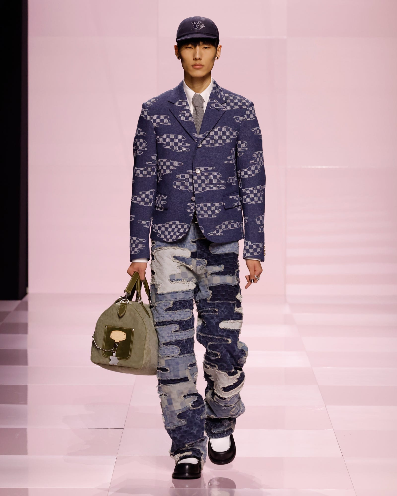 male model showcasing a unique fashion ensemble on a runway