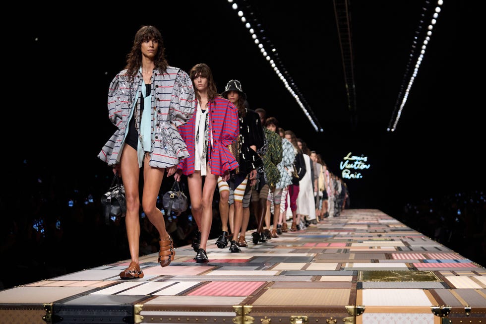 Fashion runway showcasing models in diverse outfits during a Louis Vuitton show