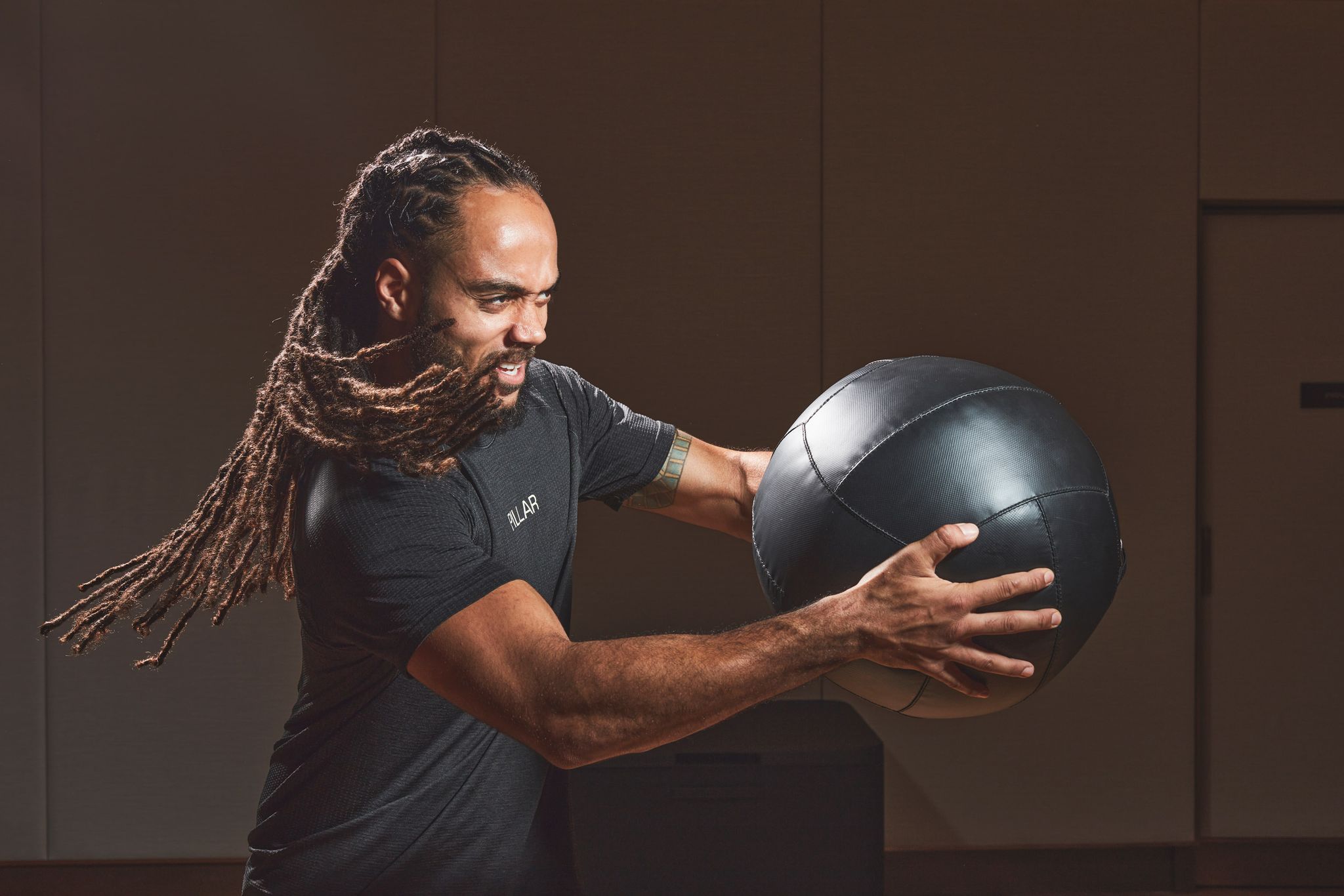 a man with long hair holding a ball