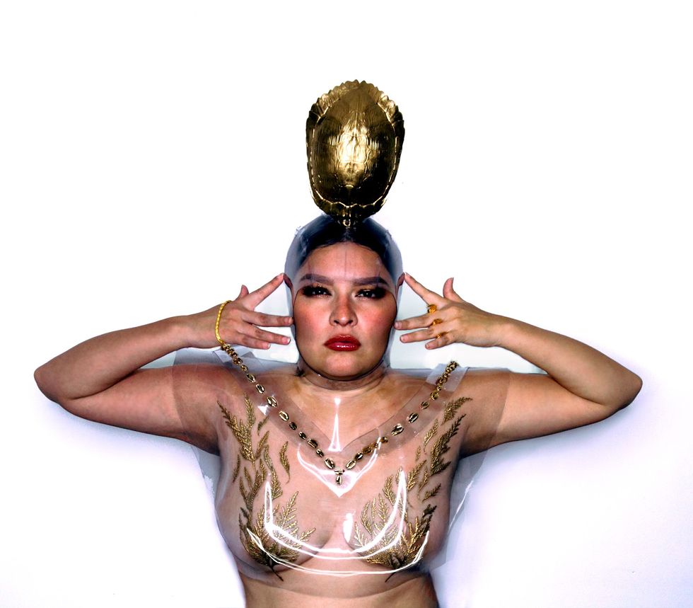 louise solomon photographed in her own creations ﻿24k gold plated miigis shells, ﻿cedar sprays, and turtle clan  ﻿