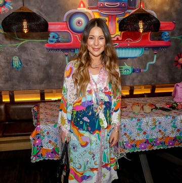 louise thompson smiles at the camera at an event