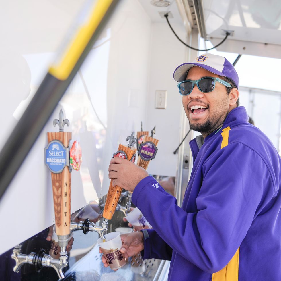 a man pours a beer after the louisiana marathon