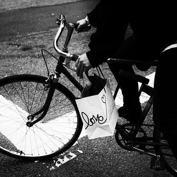 Cyclist carrying a bag that says love