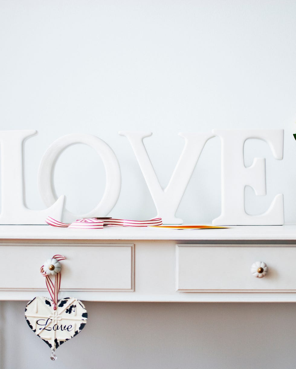 love decorations, ribbon, roses and card on desk