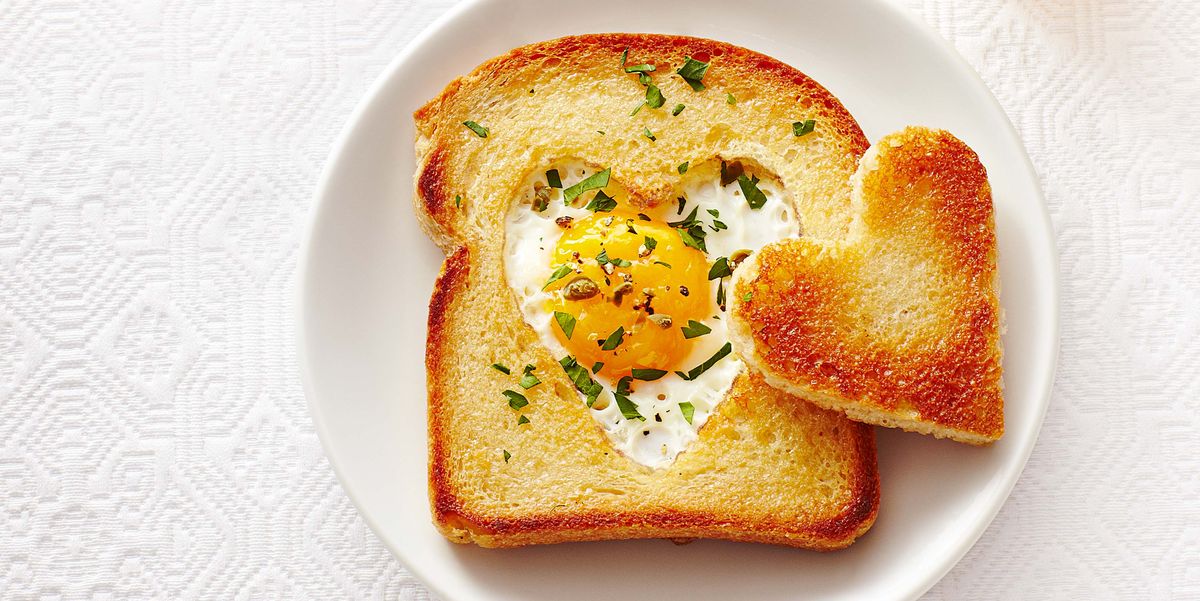 heart toast with egg in the middle on a white plate